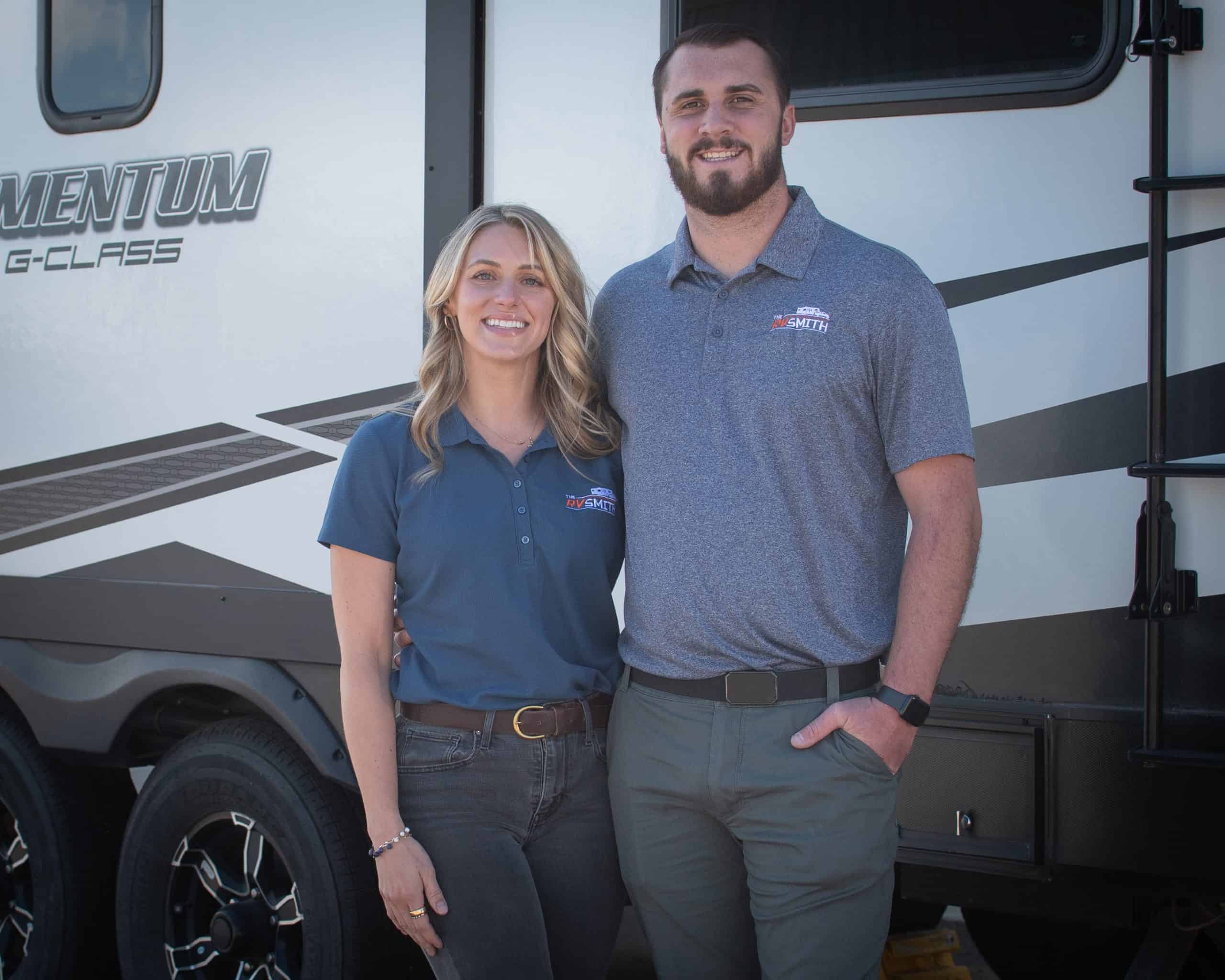 RV Smith Owners, Colton and Kenzie Smith standing by a camper.